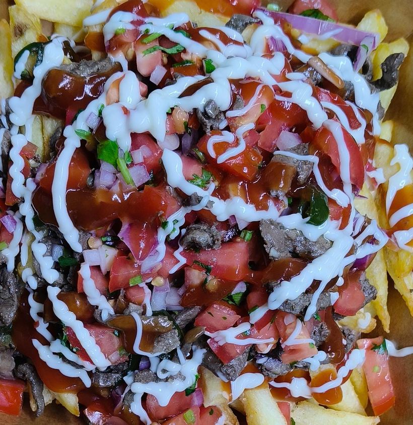 Loaded fries topped with beef liver and sauces