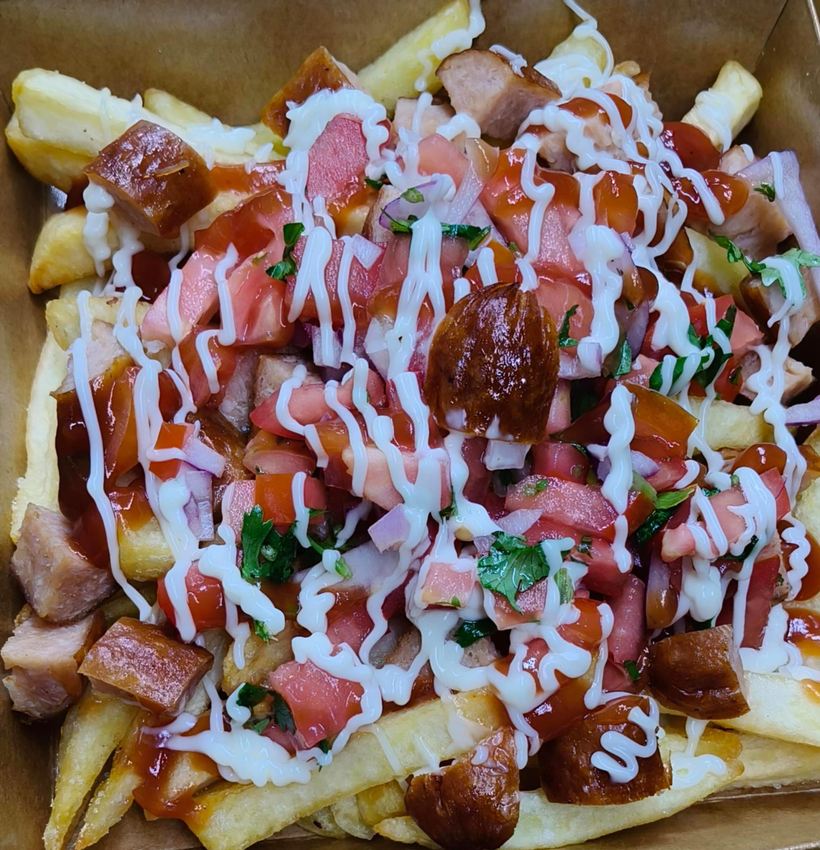 Loaded fries topped with smokie sausages and sauces