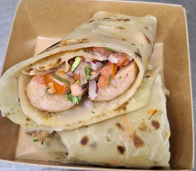 Smocha — smokie sausage rolled in a cilantro chapati